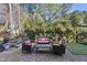 Brick patio with fire pit, grill and wooded backdrop at 2500 Shadow Hills Ct Ct, Raleigh, NC 27612