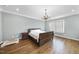 Comfortable bedroom with hardwood floors and a large bed at 2500 Shadow Hills Ct Ct, Raleigh, NC 27612