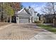 Two-story home with gray siding, gray garage door, and paver driveway at 2500 Shadow Hills Ct Ct, Raleigh, NC 27612