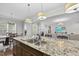 Bright kitchen features a large island with granite countertops and a double sink at 2500 Shadow Hills Ct Ct, Raleigh, NC 27612