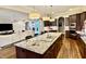 Open kitchen features a large granite island, stainless steel appliances, and hardwood floors at 2500 Shadow Hills Ct Ct, Raleigh, NC 27612