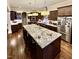 Spacious kitchen with granite countertops, dark wood cabinets, and a large island at 2500 Shadow Hills Ct Ct, Raleigh, NC 27612