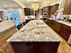 Gourmet kitchen boasts granite countertops, dark wood cabinetry, and stainless steel appliances at 2500 Shadow Hills Ct Ct, Raleigh, NC 27612