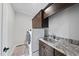 Bright laundry room with washer, dryer, and granite countertop at 2500 Shadow Hills Ct Ct, Raleigh, NC 27612