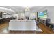 Open living room with hardwood floors, a large sectional sofa, and a view of the kitchen at 2500 Shadow Hills Ct Ct, Raleigh, NC 27612