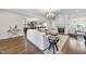 Open concept living room with a sectional sofa, fireplace, and views to kitchen and dining area at 2500 Shadow Hills Ct Ct, Raleigh, NC 27612
