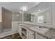 Bathroom with double vanity, large mirror, and a walk-in shower at 261 Willifords Pt Dr, Roxboro, NC 27574
