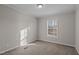 Bright bedroom with carpet flooring and a window offering natural light at 261 Willifords Pt Dr, Roxboro, NC 27574