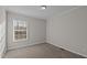 Well-lit bedroom with neutral walls and carpeted floors at 261 Willifords Pt Dr, Roxboro, NC 27574