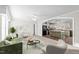 Open living room showcasing a kitchen with an island and stainless steel appliances at 261 Willifords Pt Dr, Roxboro, NC 27574