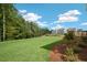 Spacious backyard with a grassy area and trees at 263 Hanging Elm Ln, Fuquay Varina, NC 27526