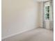 Simple, carpeted bedroom with a window and neutral walls at 263 Hanging Elm Ln, Fuquay Varina, NC 27526