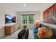 Bright bonus room features a comfy sofa, large TV, and plenty of natural light at 263 Hanging Elm Ln, Fuquay Varina, NC 27526