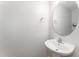 Simple bathroom with white sink and oval mirror at 31 Burford Way, Angier, NC 27501