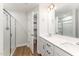 Modern bathroom with double vanity, a large mirror, and a walk-in shower at 31 Burford Way, Angier, NC 27501