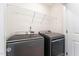 Bright laundry room, featuring side-by-side Maytag washer and dryer, and overhead shelving at 31 Burford Way, Angier, NC 27501