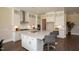 Large kitchen with white cabinets, stainless steel appliances, and large island at 341 Broomside Ave, Raleigh, NC 27603