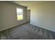 Bright bedroom with neutral carpeting and a large window at 39 Harvest Hills Ln, Dunn, NC 28334