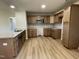 Modern kitchen with light wood cabinets and granite countertops at 39 Harvest Hills Ln, Dunn, NC 28334