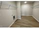 Laundry room with wire shelving and wood-look vinyl flooring at 39 Harvest Hills Ln, Dunn, NC 28334