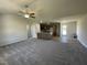 Open living room and kitchen with neutral colors and carpet at 39 Harvest Hills Ln, Dunn, NC 28334