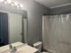 Bathroom featuring a shower, mirror with lights, and white fixtures and trim at 514 New Kent Pl, Cary, NC 27511