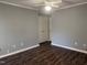 Neutral bedroom with hardwood floors, a ceiling fan, and double door closet at 514 New Kent Pl, Cary, NC 27511