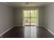 Bright bedroom with hardwood floors and sliding glass door access to the outdoor deck at 514 New Kent Pl, Cary, NC 27511