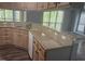 Well-lit kitchen with granite countertops, stainless steel sink, and view of the living area at 514 New Kent Pl, Cary, NC 27511