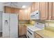 Kitchen with white appliances and light wood cabinets at 514 New Kent Pl, Cary, NC 27511