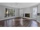 Living room with hardwood floors, fireplace and large windows at 514 New Kent Pl, Cary, NC 27511