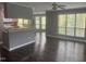 Open-concept living room featuring gray walls, hardwood floors, and a partial view of the kitchen at 514 New Kent Pl, Cary, NC 27511