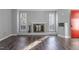 Living room with hardwood floors, fireplace and built-in shelving at 514 New Kent Pl, Cary, NC 27511