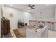 Bonus room features a comfy couch, entertainment center and a ceiling fan at 524 Brunello Dr, Wake Forest, NC 27587