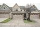 Two-story townhome with stone and siding exterior, two-car garage, and landscaping at 524 Brunello Dr, Wake Forest, NC 27587