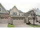 Two-story townhome with stone and siding exterior, two-car garage, and landscaping at 524 Brunello Dr, Wake Forest, NC 27587