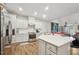 Modern kitchen with island, stainless steel appliances, and white cabinets at 524 Brunello Dr, Wake Forest, NC 27587