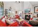 Spacious living room with red leather sofas, fireplace, and hardwood floors at 524 Brunello Dr, Wake Forest, NC 27587
