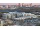 Stunning aerial view of city skyline with shops and parking lots in the foreground at 615 Daniels St # 316, Raleigh, NC 27605