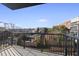 Balcony with black metal railing and a view of the cityscape with vibrant trees at 615 Daniels St # 316, Raleigh, NC 27605