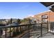A balcony with a view of a modern apartment building and lush greenery offers serene city living at 615 Daniels St # 316, Raleigh, NC 27605
