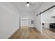 Bedroom with hardwood floors, closet, and slider to a kitchen area at 615 Daniels St # 316, Raleigh, NC 27605