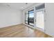 Bright bedroom featuring hardwood floors, a large window, and ample natural light at 615 Daniels St # 316, Raleigh, NC 27605
