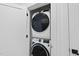 A stacked, white washer and dryer set in a closet, perfect for space-saving convenience at 615 Daniels St # 316, Raleigh, NC 27605