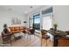 Open living room area with modern decor, large windows, and access to outdoor balcony at 615 Daniels St # 316, Raleigh, NC 27605