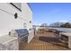 A modern rooftop deck features a built-in outdoor kitchen and stainless steel grill at 615 Daniels St # 316, Raleigh, NC 27605