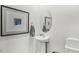 Small half bathroom with pedestal sink and oval mirror at 64 Tributary Way, Fuquay Varina, NC 27526