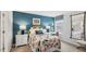 Bedroom with floral comforter, teal walls, and workspace at 64 Tributary Way, Fuquay Varina, NC 27526
