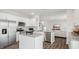 Open concept kitchen with island and stainless steel appliances at 64 Tributary Way, Fuquay Varina, NC 27526