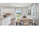 Eat-in kitchen with white cabinets, granite counters, and sliding door at 64 Tributary Way, Fuquay Varina, NC 27526